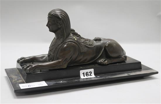 A bronze sphinx on slate base